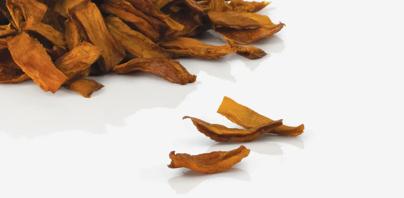 A pile of dried mangoon a white background
