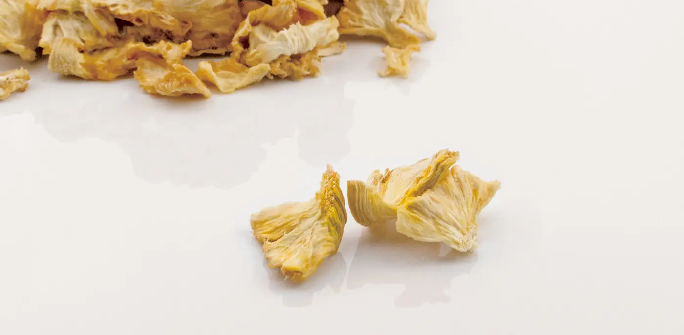 A pile of dried pineapples on a white background