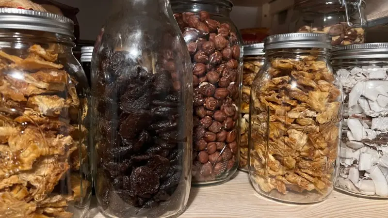 Photo of several large jars filled with various nuts and dried fruit, gebana.com