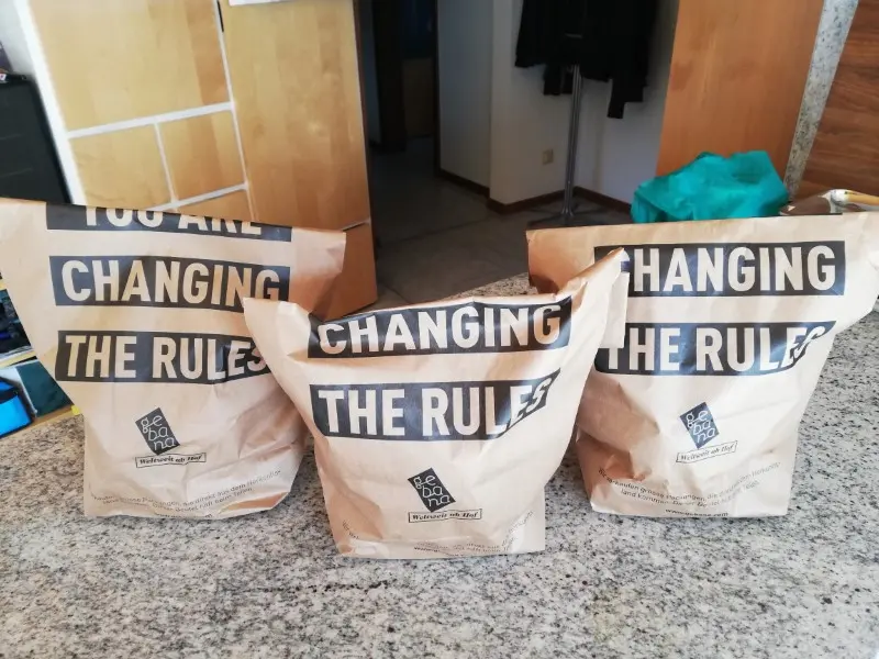 Photo of three paper bags with the inscription 'You are changing the rules', gebana.com